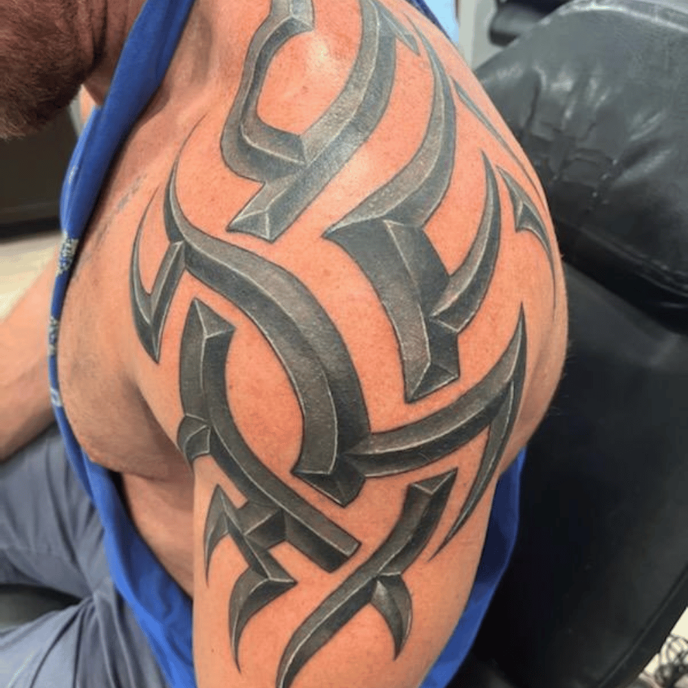 man with metallic shoulder tattoo